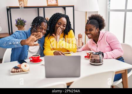 African american friends having breakfast using laptop at home Stock Photo
