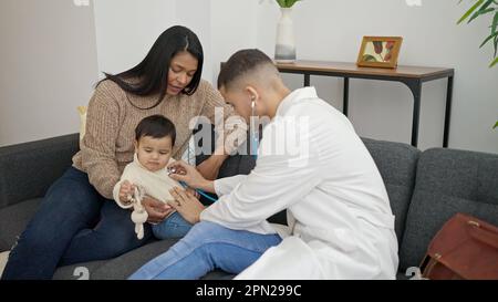 Couple and son examining baby with stethoscope at clinic Stock Photo