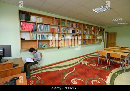 Library of the medrese. Muslim boy reading a book. October 21, 2018. Islamic culture centre, Kiev, Ukraine Stock Photo