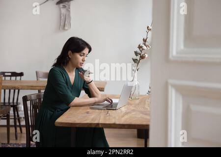 Woman holds smartphone talk to client on speakerphone at workplace Stock Photo