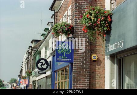 Hanging flower displays from shops and other enterprises near the busy Stratford Rod in Shirley, Solihull, West Midlands in August 2010.   5849-5851 series-Stratford Road Shirley Solihull/Beatties Solihull Stock Photo