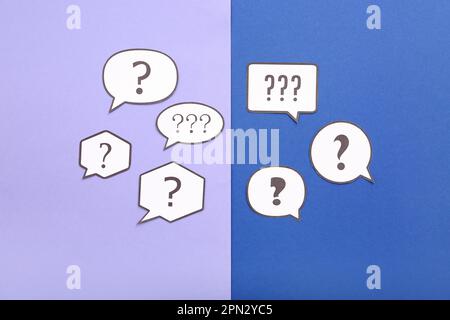 Speech bubbles with question marks on color background Stock Photo