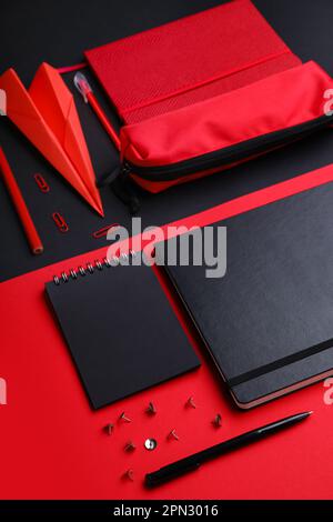 Composition with, notebooks stationery supplies and paper plane on color background Stock Photo