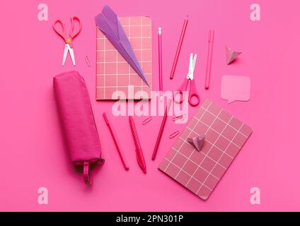 Composition with stationery supplies and paper planes on pink background Stock Photo