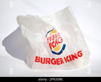 Ho Chi Minh City, Vietnam - April 8, 2023: Empty plastic bag with red and yellow Burger King logo isolated on white. Trash left after ordering takeout Stock Photo