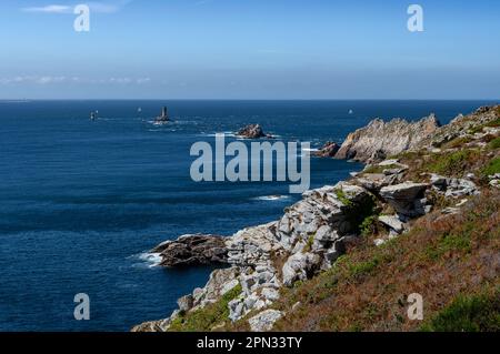 Spectacular Cliffs And Lighthouse At Peninsula Pointe Du Raz At The Finistere Atlantic Coast In Brittany, France Stock Photo