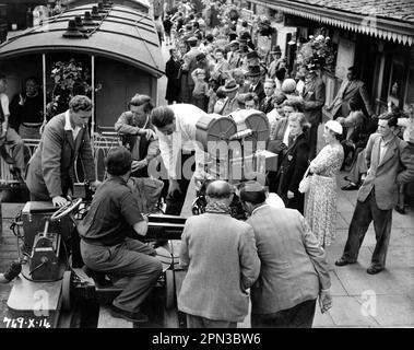 Director CHARLES CRICHTON and Camera / Movie Crew on set location candid filming a scene at railway station for THE TITFIELD THUNDERBOLT 1953 director CHARLES CRICHTON original screenplay T.E.B. Clarke music Georges Auric producer Michael Truman An Ealing Studios Michael Balcon Production / General Film Distributors (GFD) Stock Photo