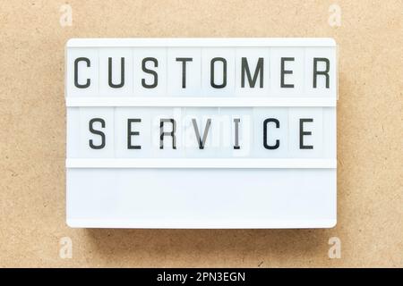 Lightbox with word customer service on wood background Stock Photo
