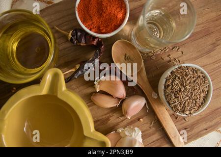 View from above of a wooden board with some of the necessary ingredients to make the red mojopicón sauce, a sauce from the Canary Islands Stock Photo