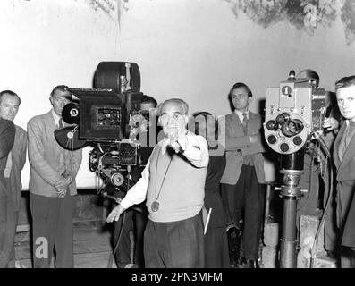 Cinematographer OTTO HELLER on set candid with Film / Camera Crew during filming of WHO DONE IT ? 1956 director BASIL DEARDEN story / screenplay T.E.B. Clarke costume design Anthony Mendleson co-producers Basil Dearden and Michael Relph executive producer Michael Balcon Ealing Studios / Michael Balcon Productions / The Rank Organisation Stock Photo