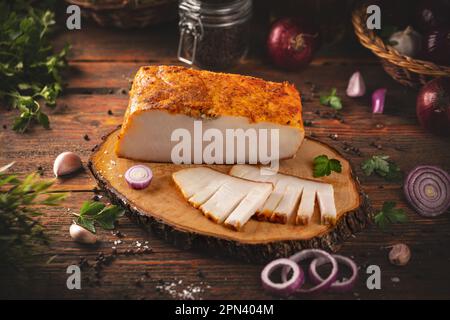 Hungarian lard pork with spicy red pepper powder on wooden cutting board Stock Photo