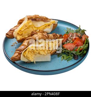 Restaurant breakfast menu concept, scrambled eggs in croissant with cheese and ham Stock Photo