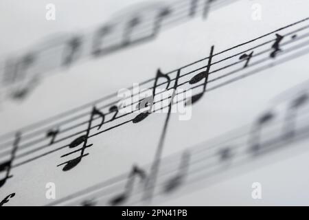 Close up image of a small section of sheet music showing lines and notes with blurred edges Stock Photo