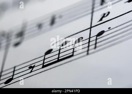 Close up image of a small section of sheet music showing lines and notes with blurred edges Stock Photo