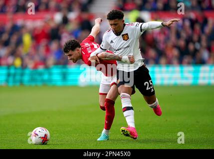 Nottingham Forest's Neco Williams (left) and Manchester United's Jadon Sancho battle for the ball during the Premier League match at the City Ground, Nottingham. Picture date: Sunday April 16, 2023. Stock Photo