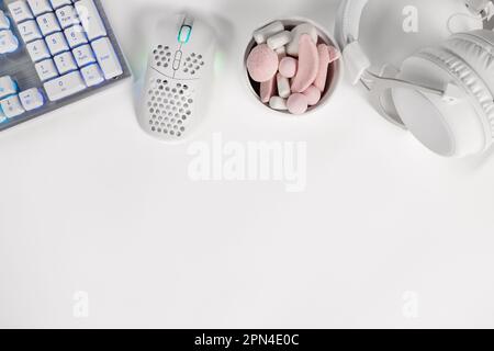 Top view of modern gaming gadgets and marshmallows on desk Stock Photo