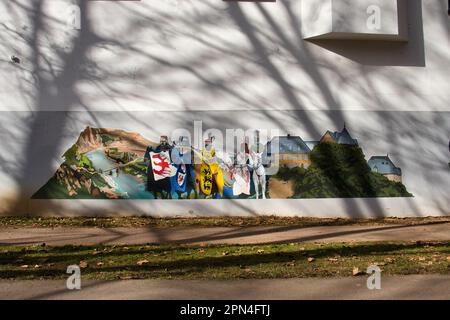 Bad Kreuznach, Germany - February 25, 2021: Side of a building wtih a painting and shadows from trees on a winter day in Bad Kreuznach, Germany. Stock Photo