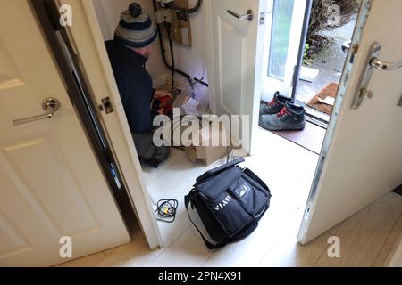 A BT Openreach man pictured installing Fibre Optic Broadband into a home in Chichester, West Sussex, UK. Stock Photo