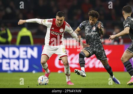 AMSTERDAM - (L-R) Steven Berghuis of Ajax, Jermy Antonisse of FC Emmen during the Dutch premier league match between Ajax Amsterdam and FC Emmen at the Johan Cruijff ArenA on April 16, 2023 in Amsterdam, Netherlands. ANP MAURICE VAN STONE Stock Photo