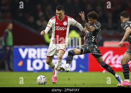 AMSTERDAM - (L-R) Steven Berghuis of Ajax, Jermy Antonisse of FC Emmen during the Dutch premier league match between Ajax Amsterdam and FC Emmen at the Johan Cruijff ArenA on April 16, 2023 in Amsterdam, Netherlands. ANP MAURICE VAN STONE Stock Photo