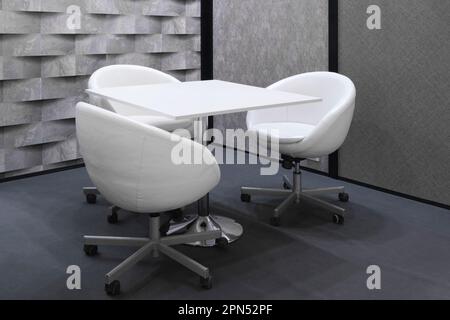 White chairs armchairs and a table in a meeting room Stock Photo