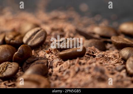 Roasted coffee beans lie together with chocolate crumbled into small pieces, fragrant coffee together with chocolate crumbs Stock Photo