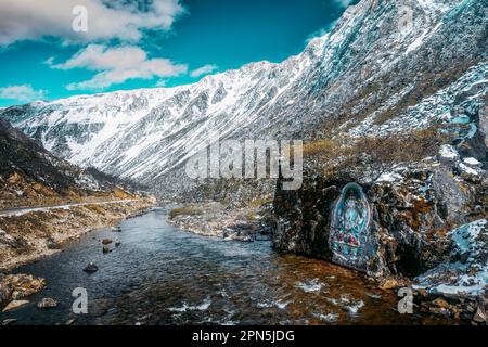 Painted stone carvings of Tibetan Buddha statues in the high mountains of Western Sichuan, China, very majestic Stock Photo