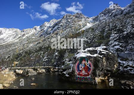 Painted stone carvings of Tibetan Buddha statues in the high mountains of Western Sichuan, China, very majestic Stock Photo