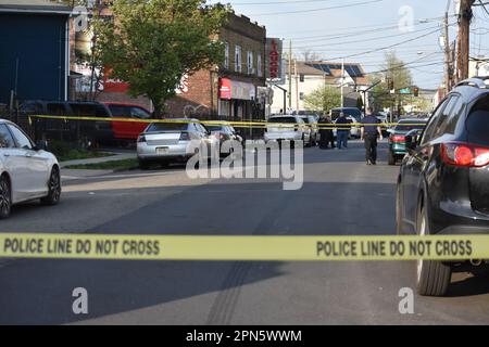 Elizabeth, United States. 16th Apr, 2023. Police tape blocks the area as officers investigate the crime scene. Several vehicles were reportedly struck by gunfire along with a person struck by gunfire in Elizabeth, Sunday afternoon on Jackson Avenue and Bond Street. Other intersections were also closed off and being scoured for evidence. Credit: SOPA Images Limited/Alamy Live News Stock Photo