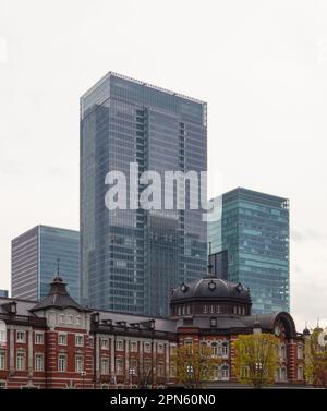 Historical Tokyo station building and modern skyscrapers as a background in Tokyo, Japan Stock Photo