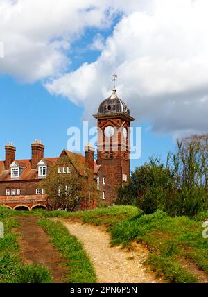 A view of the clock tower at HM Prison at St James Hill on Mousehold Heath overlooking the City of Norwich, Norfolk, United Kingdom. Stock Photo