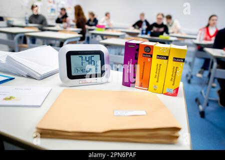 Oldenburg, Germany. 17th Apr, 2023. A digital clock and several dictionaries stand on a table at the Graf-Anton-Günther-Schule (GAG) before the start of the written Abitur exams in history. In Lower Saxony, the final exams for the 2023 Abitur class will begin. The exams in various subjects will be written by May 9, 2023. Credit: Hauke-Christian Dittrich/dpa/Alamy Live News Stock Photo