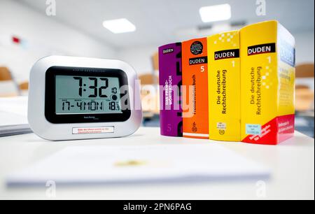 Oldenburg, Germany. 17th Apr, 2023. A digital clock and several dictionaries stand on a table at the Graf-Anton-Günther-Schule (GAG) before the start of the written Abitur exams in history. In Lower Saxony, the final exams for the 2023 Abitur class will begin. The exams in various subjects will be written by May 9, 2023. Credit: Hauke-Christian Dittrich/dpa/Alamy Live News Stock Photo