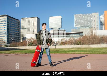 Shot of a young man holding a skateboard outside. Stock Photo