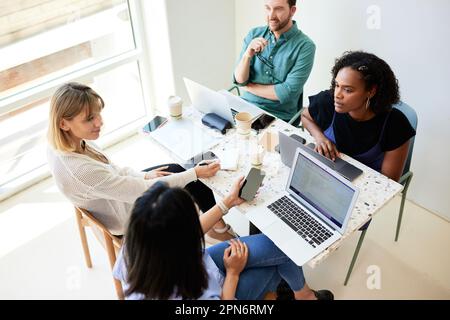 Multiracial colleagues planning business strategy at table in cafe Stock Photo
