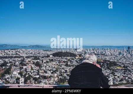 The stunning skyline of San Francisco can be seen from Twin Peaks, with the iconic Transamerica Pyramid and Coit Tower visible in the distance. San Francisco is renowned for its scenic vistas and iconic landmarks, but few are as breathtaking as Twin Peaks. Located at an elevation of 922 feet, Twin Peaks is one of the city's highest points, providing a panoramic view of San Francisco Bay, downtown San Francisco, and beyond. It's a popular destination for tourists and locals alike, offering a stunning perspective of the city's beauty. Twin Peaks San Francisco is named for the two peaks that make Stock Photo