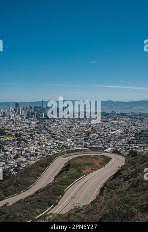 March 24, 2023, San Francisco, California, United States: The stunning skyline of San Francisco can be seen from Twin Peaks, with the iconic Transamerica Pyramid and Coit Tower visible in the distance. San Francisco is renowned for its scenic vistas and iconic landmarks, but few are as breathtaking as Twin Peaks. Located at an elevation of 922 feet, Twin Peaks is one of the city's highest points, providing a panoramic view of San Francisco Bay, downtown San Francisco, and beyond. It's a popular destination for tourists and locals alike, offering a stunning perspective of the city's beauty. Twi Stock Photo