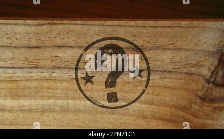 Question mark stamp printed on wooden box. Faq help query and answer concept. Stock Photo