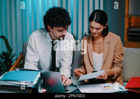Business team working on project documents late at night Stock Photo