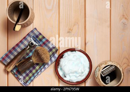 Top view of shaving equip, razor blade and brush and foam. Barbershop theme backgrounds. Copy space for text Stock Photo