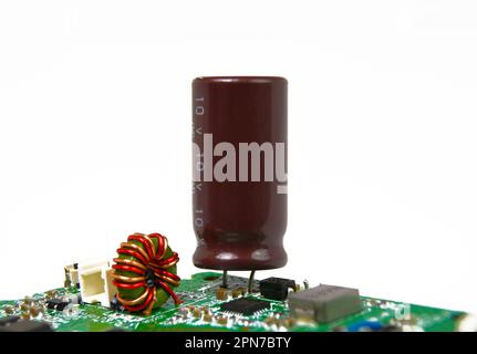 Electrolyte or electrolytic capacitors isolated in electronic circuit board on white background, electronic parts concept. Stock Photo