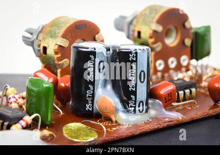 Electrolyte or electrolytic capacitors row on electronic circuit board, electronic parts concept. Stock Photo