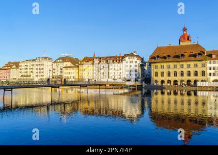 Lucerne, Switzerland - February 20, 2023: View of the Reuss River, with various buildings, locals, and visitors, in Lucerne (Luzern), Switzerland Stock Photo