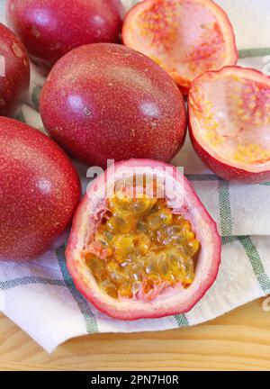 Heap of Fresh Ripe Passion Fruits on Checkers Dish Towel Stock Photo