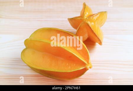 Fresh Ripe Carambola or Star Fruits Isolated on Wooden Background Stock Photo
