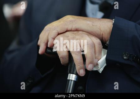 Nordhausen, Germany. 17th Apr, 2023. The hands of survivor Jerry Wartski, supported by a walking stick, taken at the commemoration ceremony for the 78th day of the liberation of Mittelbau-Dora concentration camp. U.S. troops had reached the camp on April 11, 1945. Since the date this year coincided with the Jewish Passover holiday, the commemoration will be held held a little later. Credit: Matthias Bein/dpa/Alamy Live News Stock Photo