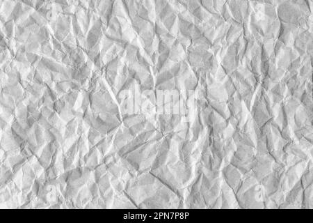 Recycled crumpled gray paper texture background. Wrinkled and creased abstract backdrop, wallpaper with copy space, top view. Stock Photo