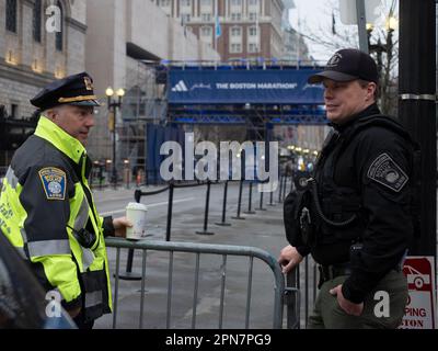 Boston, Massachusetts, USA. 17th Apr, 2023. Boston Police officers guard the finish line of the 127th Boston Marathon. Ten years ago, a bomb blast there killed three and injured scores of others. This year nearly 30,000 runners will run the 26.2 mile course, coming from more than 100 countries. (Credit Image: © Sue Dorfman/ZUMA Press Wire) EDITORIAL USAGE ONLY! Not for Commercial USAGE! Credit: ZUMA Press, Inc./Alamy Live News Stock Photo