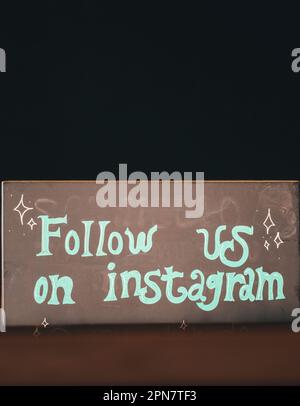A chalkboard sign with the words 'Follow us on Instagram' written on it Stock Photo