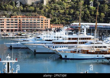 Monte-Carlo, Monaco - April 16, 2023: World's largest and most expensive superyachts tightly packed in Monte-Carlo, Monaco's port, with Formula 1 Gran Stock Photo